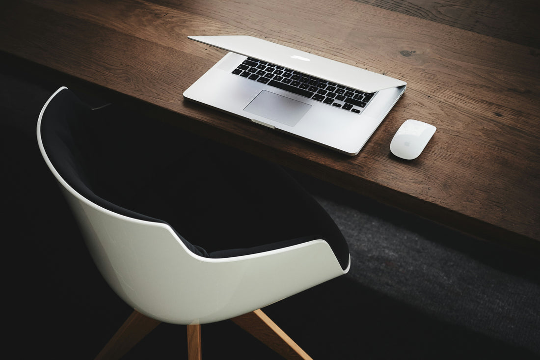 An ergonomic workspace setup with a comfortable chair, adjustable desk, and properly positioned screen.